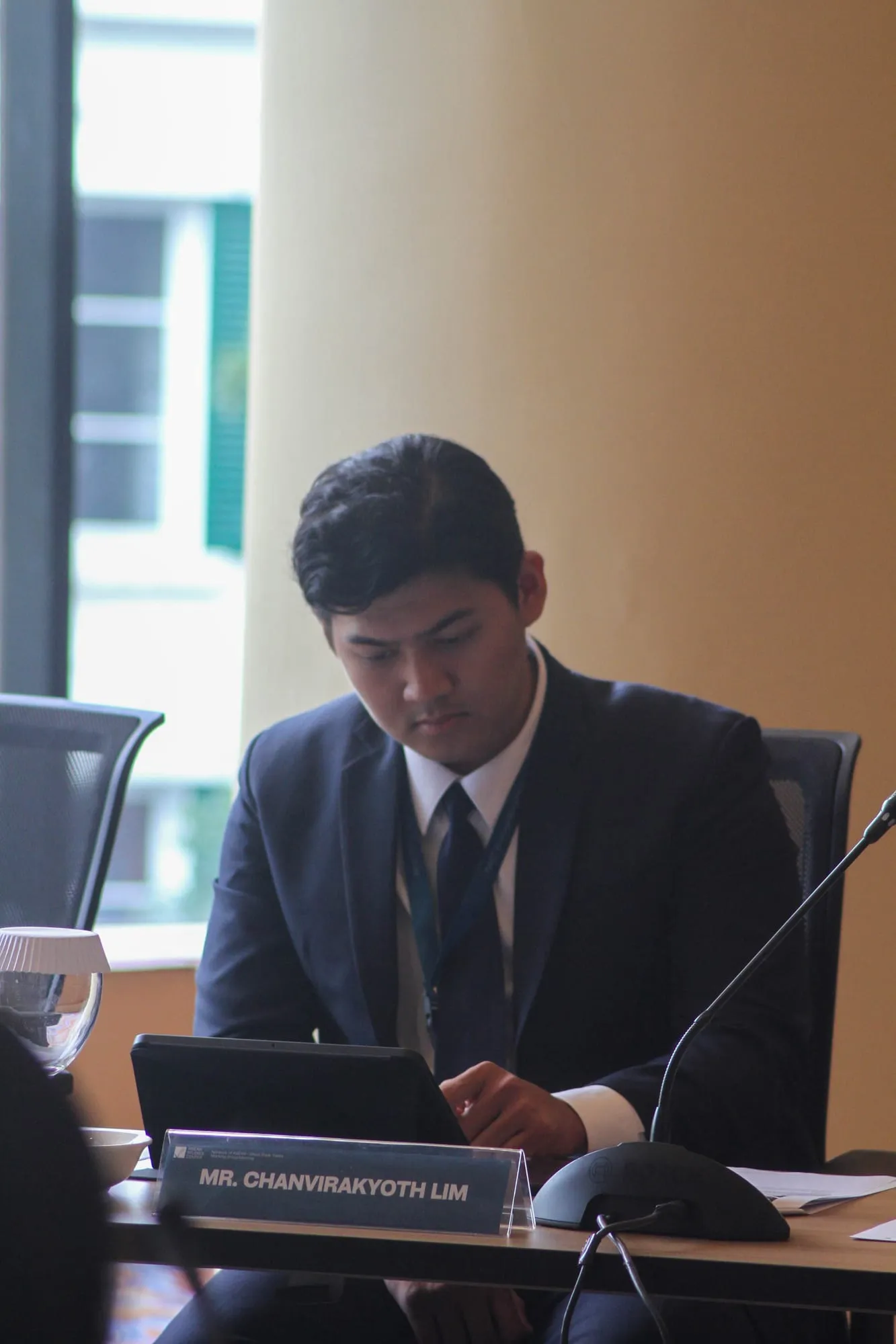 Lim Chanvirakyoth reading on a laptop during a session