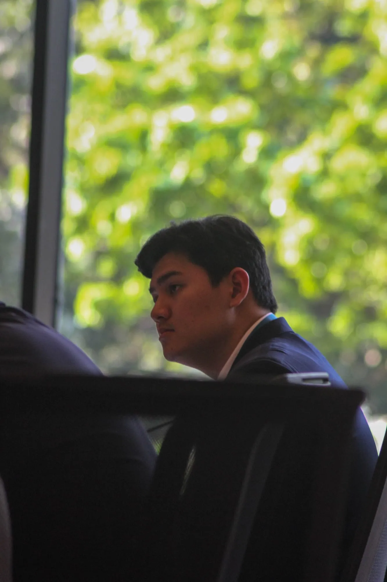 Lim Chanvirakyoth by a bright window, looking across the room