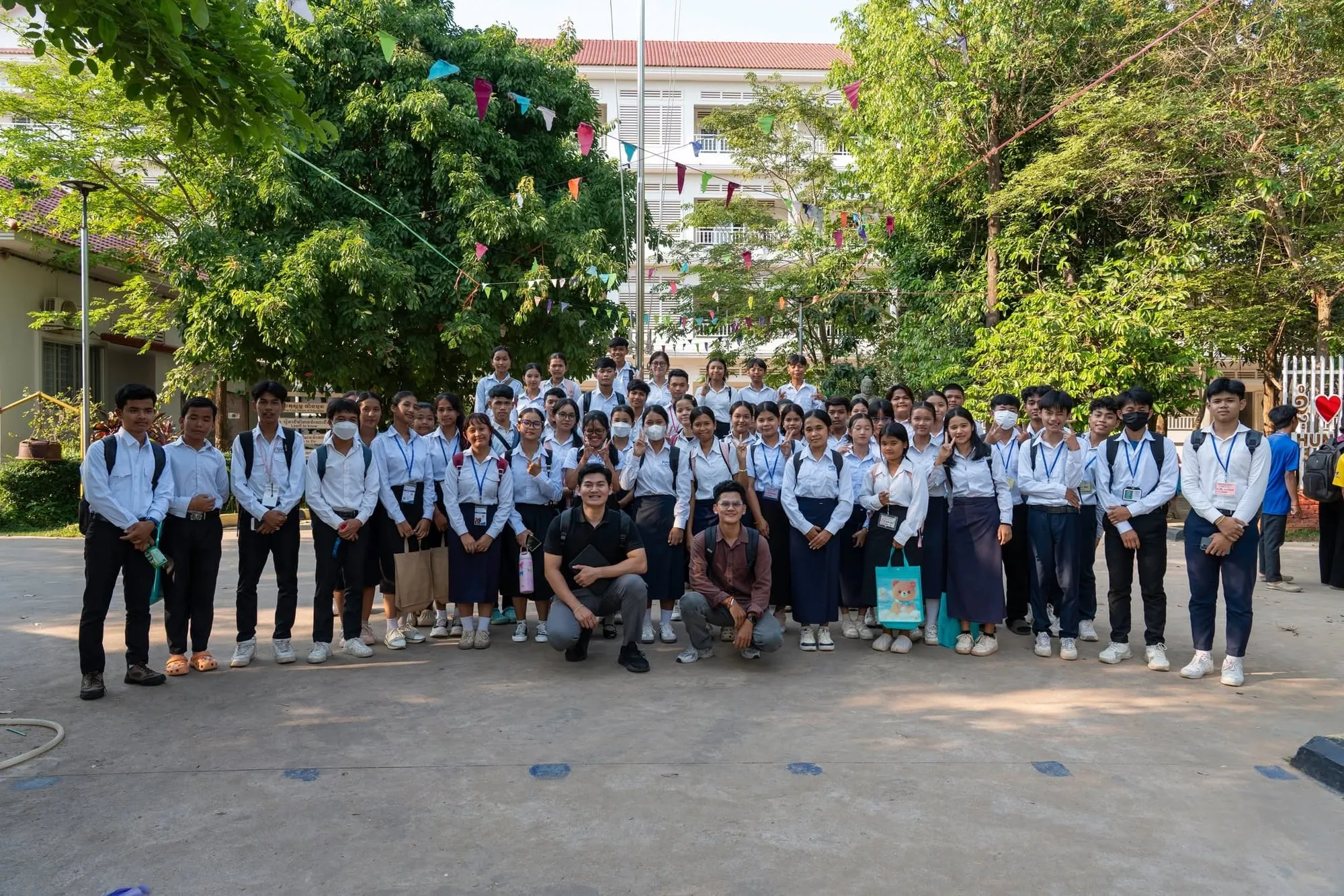 Large group photo of students in uniform in the schoolyard