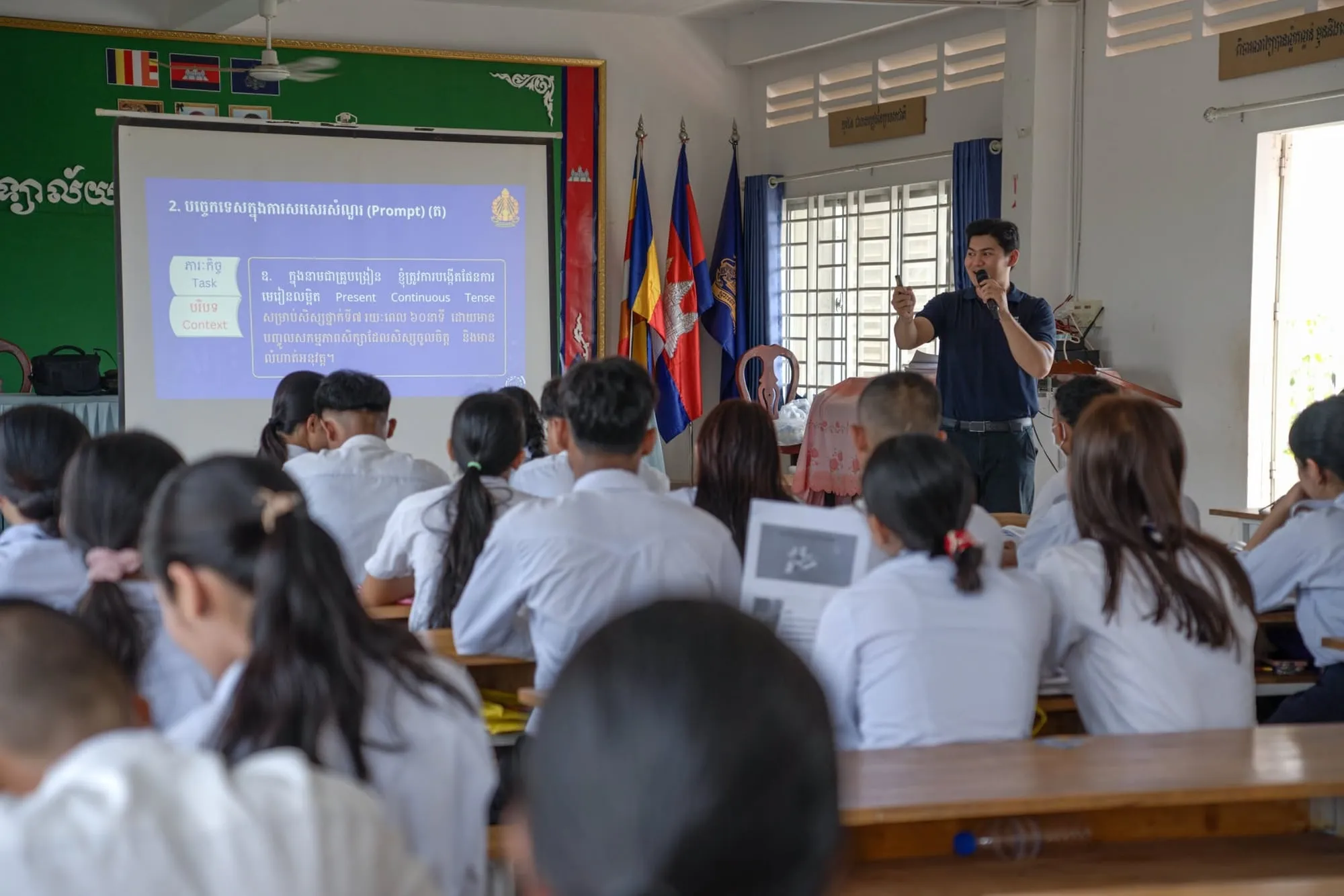 Lim Chanvirakyoth presenting to a room of students, seen from the back of the room